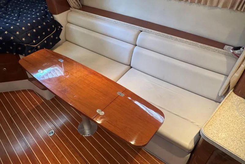 Slide: The Image of 2005 Regal 3360 Window Express interior with wooden table and white seating. - 25