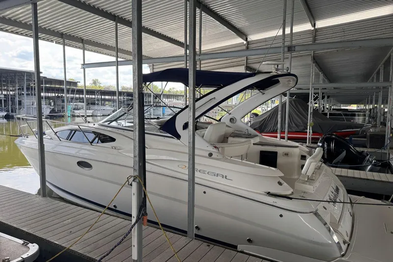 Slide: The Image of 2005 Regal 3360 Window Express boat docked in a covered marina. - 3