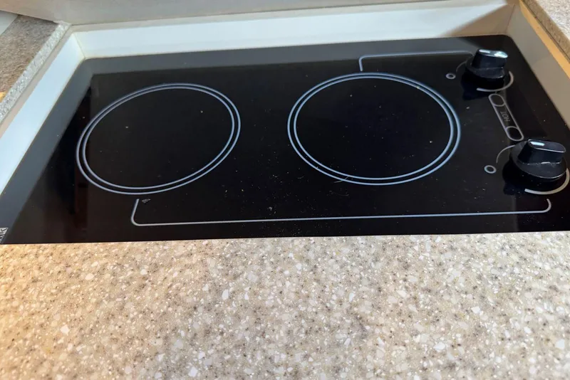 Slide: The Image of 2005 Regal 3360 Window Express stovetop with two burners and control knobs. - 30