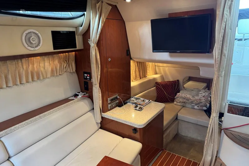 Slide: The Image of 2005 Regal 3360 Window Express interior with seating, TV, and wood accents. - 32