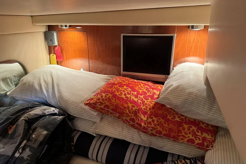 Slide: The Image of Cozy cabin interior of 2005 Regal 3360 Window Express with pillows and TV. - 34