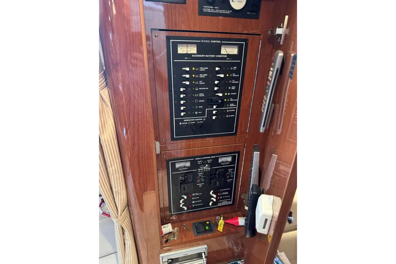 Slide: The Image of Control panel of a 2005 Regal 3360 Window Express boat, featuring various switches and meters. - 36
