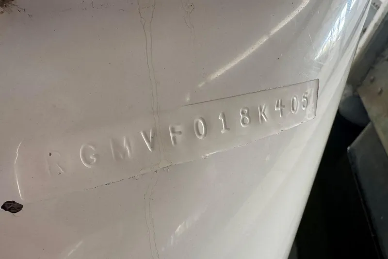 Slide: The Image of 2005 Regal 3360 Window Express hull identification number embossed on white surface. - 46