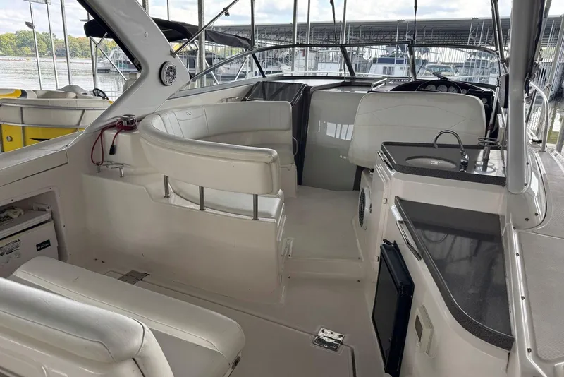 Slide: The Image of 2005 Regal 3360 Window Express boat interior with seating and kitchenette. - 7