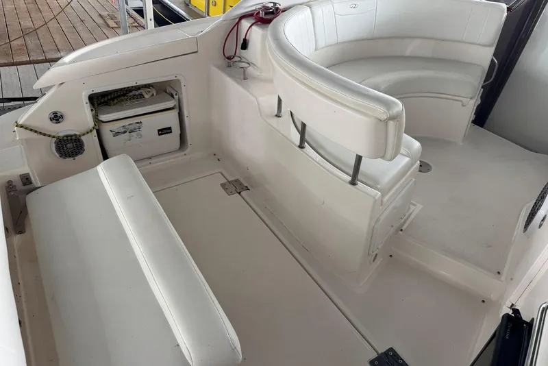 Slide: The Image of 2005 Regal 3360 Window Express boat interior with white seating and storage compartment. - 8