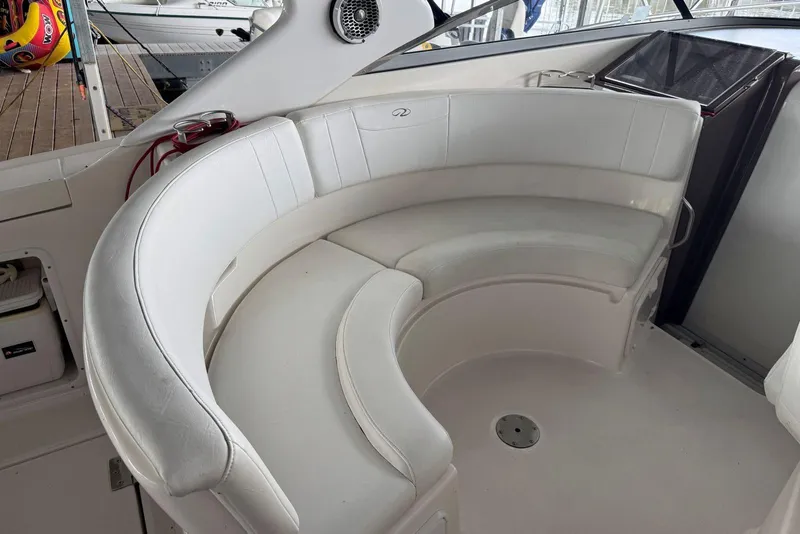 Slide: The Image of 2005 Regal 3360 Window Express boat interior with white curved seating. - 9