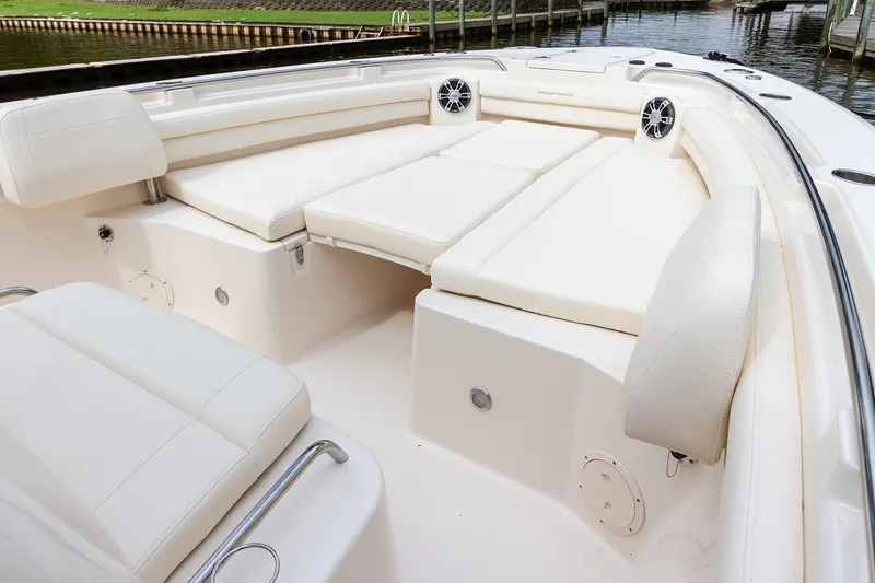 Slide: The Image of 2010 Grady-White Canyon 336 boat interior with seating and dual outboard motors. - 15