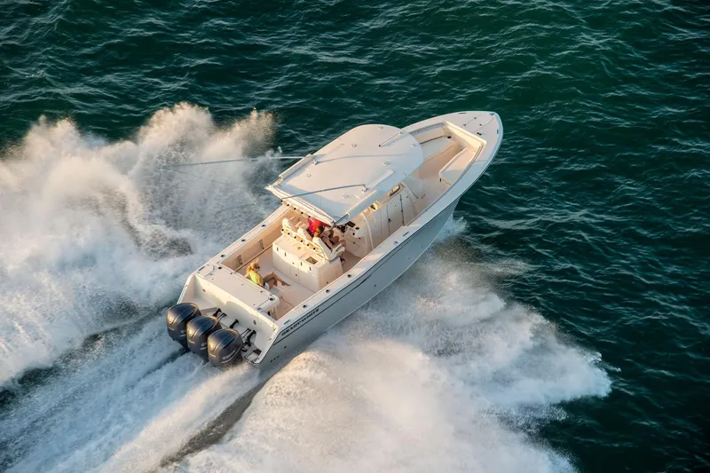 Slide: The Image of 2010 Grady-White Canyon 336 boat with open storage compartments and rod holders. - 19