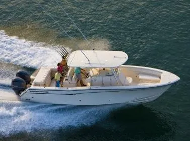 Slide: The Image of 2010 Grady-White Canyon 336 boat docked near urban skyline. - 2