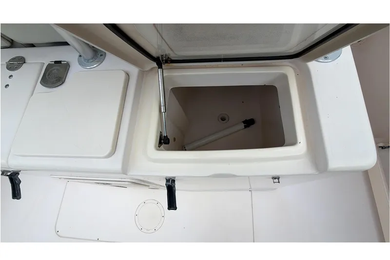 Slide: The Image of 2010 Grady-White Canyon 336 boat interior with rod holders and storage compartments. - 21