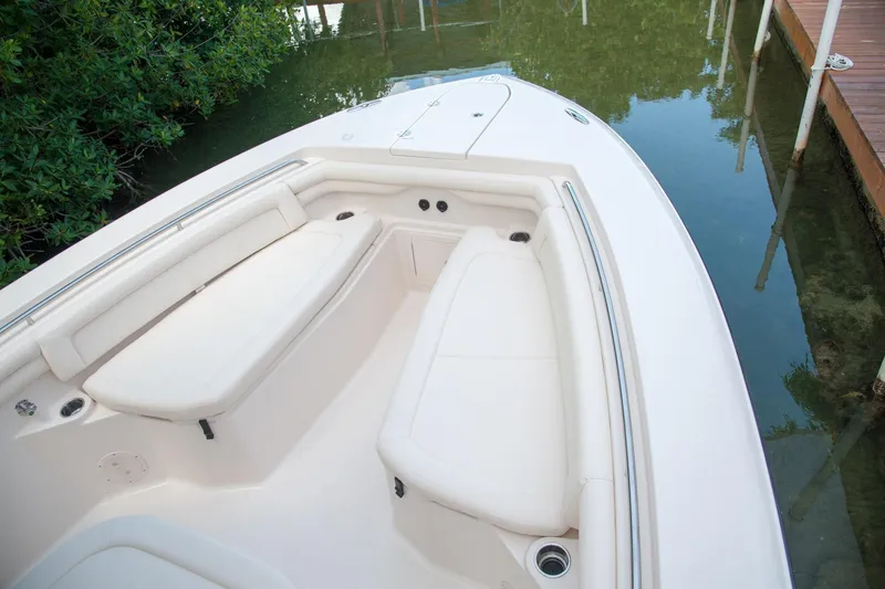 Slide: The Image of 2010 Grady-White Canyon 336 boat deck with seating and storage compartments. - 25