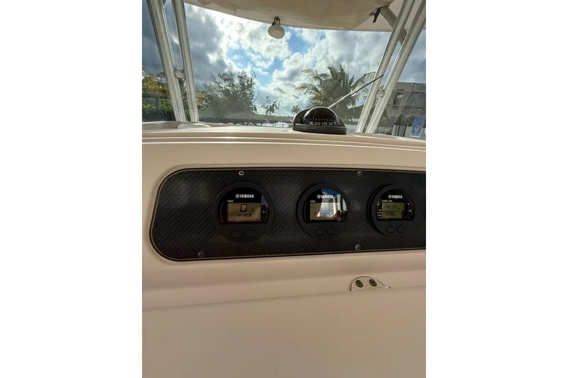 Slide: The Image of 2010 Grady-White Canyon 336 boat interior with steering console and seating area. - 28