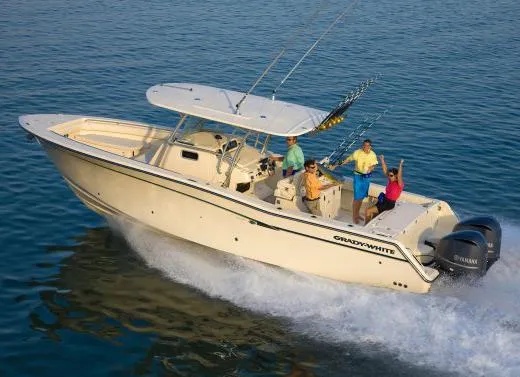 Slide: The Image of 2010 Grady-White Canyon 336 boat docked in a marina with city skyline backdrop. - 3