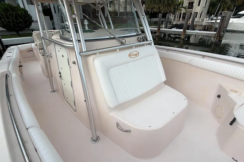 Slide: The Image of 2010 Grady-White Canyon 336 boat canopy under cloudy sky with palm trees. - 31