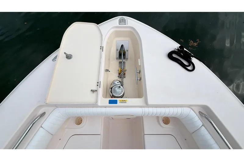 Slide: The Image of 2010 Grady-White Canyon 336 boat interior with cushioned seating and storage compartments. - 37