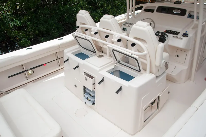 Slide: The Image of 2010 Grady-White Canyon 336 boat docked, featuring spacious seating and modern design. - 4