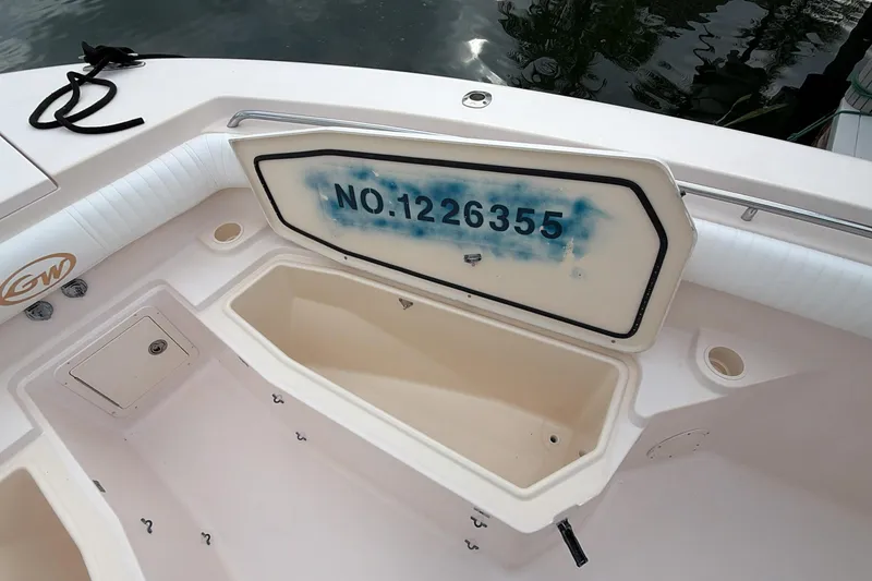 Slide: The Image of 2010 Grady-White Canyon 336 boat with open storage compartment and registration number. - 41
