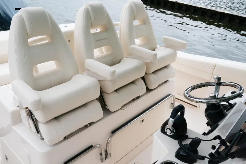 Slide: The Image of 2010 Grady-White Canyon 336 boat with dual Yamaha outboard engines docked by the water. - 8