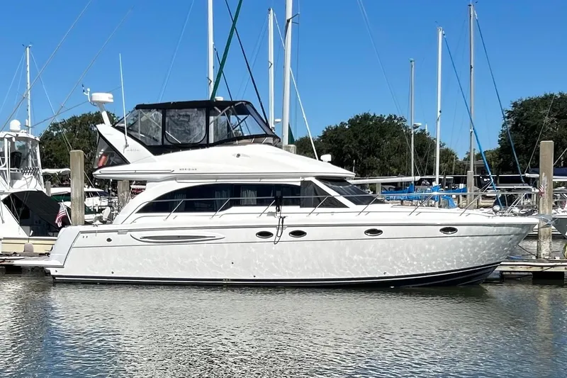 The Image of 2007 Meridian 411SB yacht docked at marina, clear sky, calm water. - 0