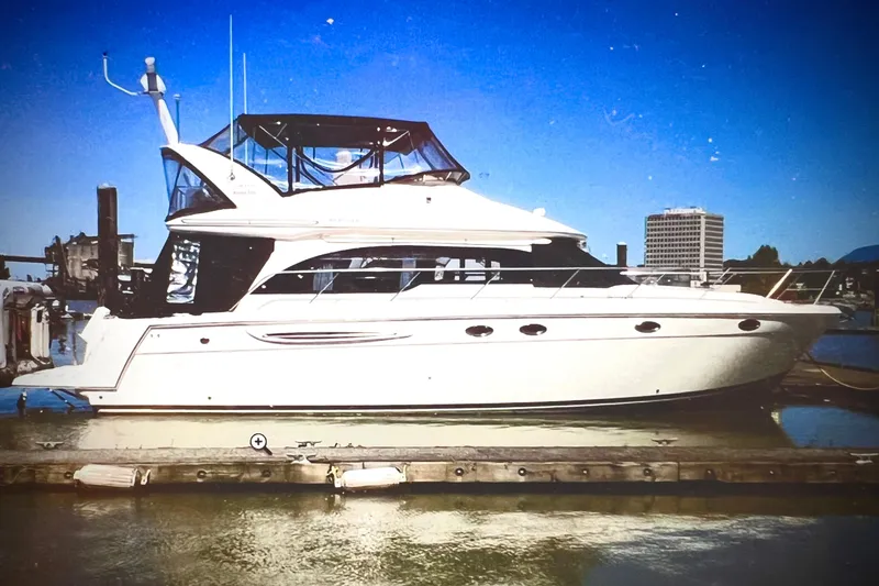 Slide: The Image of 2007 Meridian 411SB yacht docked at marina under clear blue sky. - 1