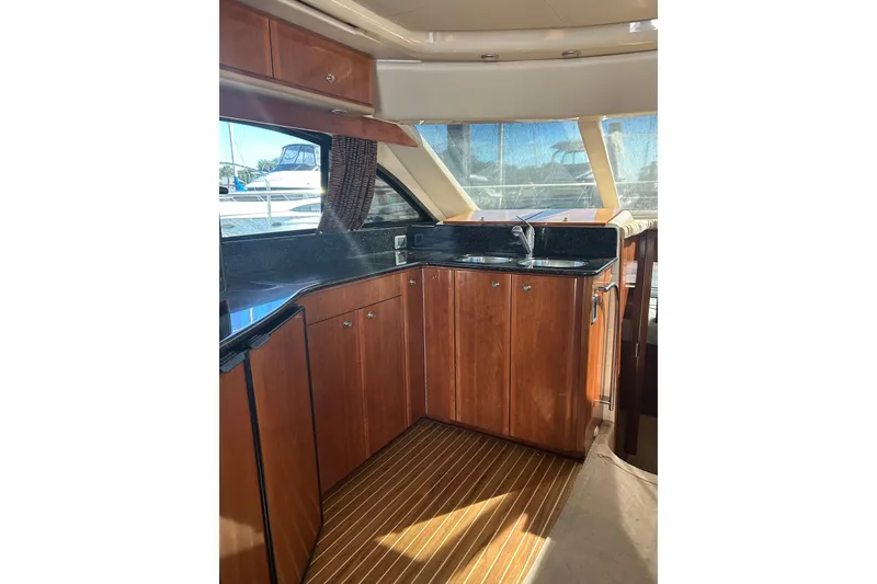 Slide: The Image of Luxurious 2007 Meridian 411SB yacht interior with sleek wooden cabinetry and modern kitchen amenities. - 12