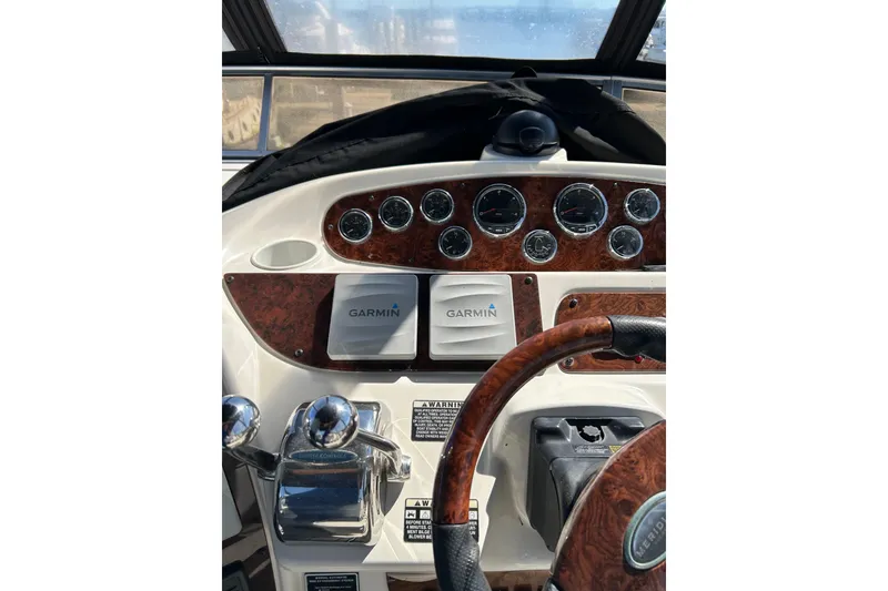 Slide: The Image of 2007 Meridian 411SB yacht dashboard with Garmin navigation and wood accents. - 15