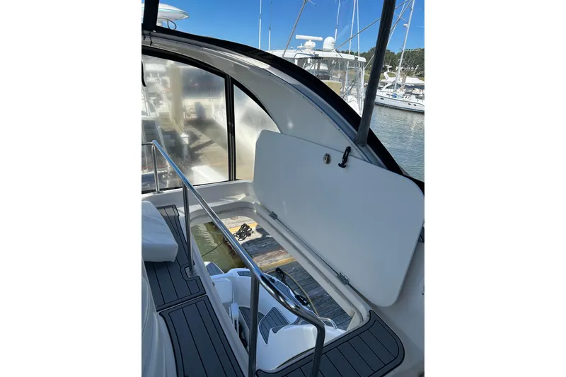 Slide: The Image of 2007 Meridian 411SB yacht interior with open storage compartment, docked at marina. - 16
