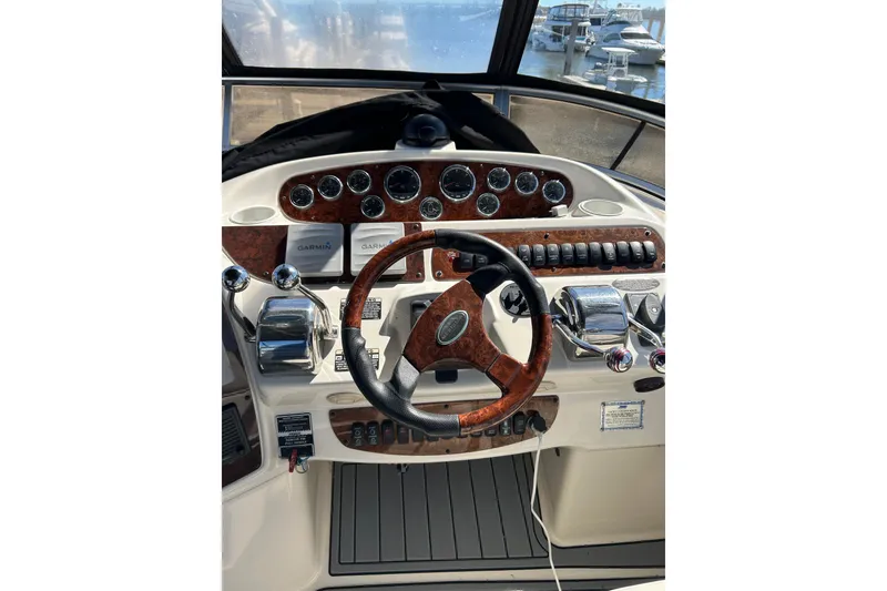 Slide: The Image of Helm of 2007 Meridian 411SB yacht with wood accents and navigation controls. - 18