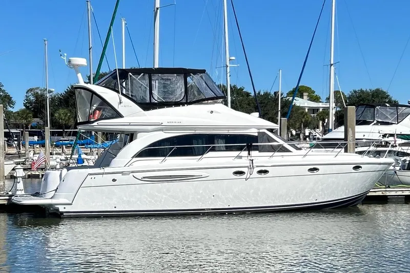 Slide: The Image of 2007 Meridian 411SB yacht docked at marina under clear blue sky. - 2