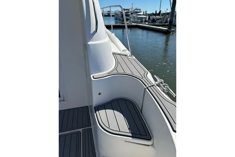 Slide: The Image of 2007 Meridian 411SB yacht deck with sleek design and marina view. - 25