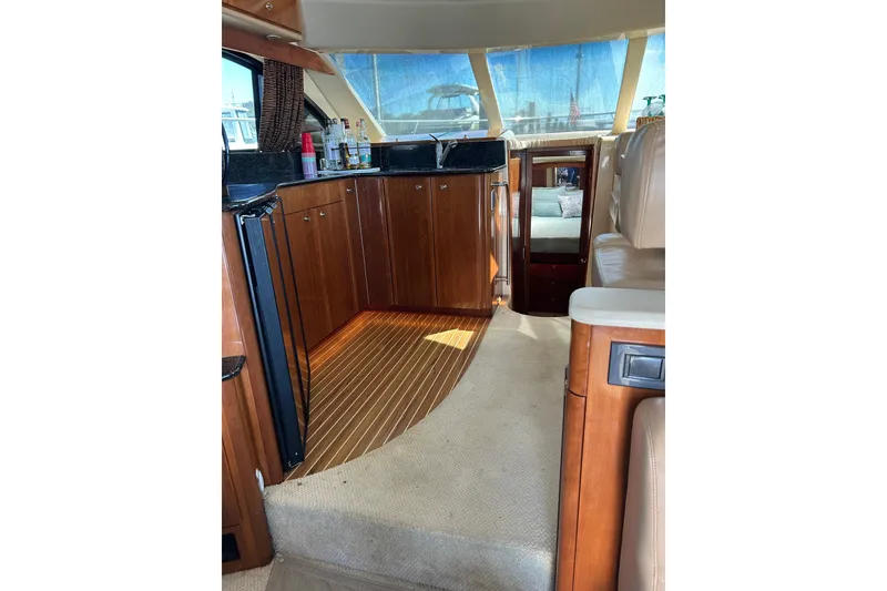 Slide: The Image of Interior of 2007 Meridian 411SB yacht with wooden cabinetry and seating area. - 31