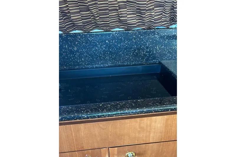 Slide: The Image of Granite countertop and wooden cabinet in 2007 Meridian 411SB yacht interior. - 33