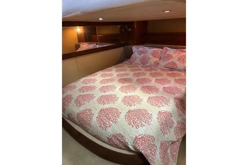 Slide: The Image of Luxurious 2007 Meridian 411SB yacht bedroom with coral-patterned bedding. - 35