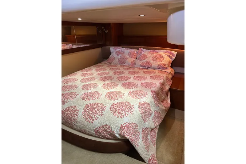 Slide: The Image of Cozy bedroom in 2007 Meridian 411SB yacht with coral-patterned bedding. - 36