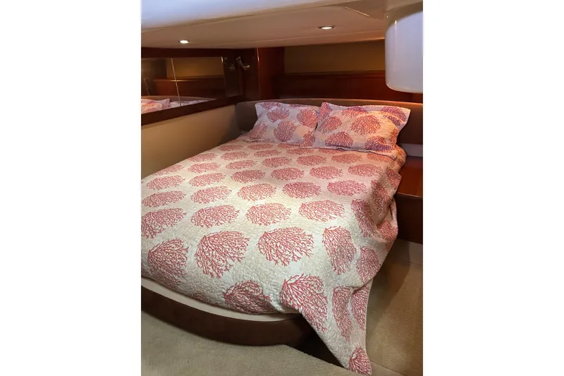 Slide: The Image of Cozy bedroom in 2007 Meridian 411SB yacht with coral-patterned bedding. - 37