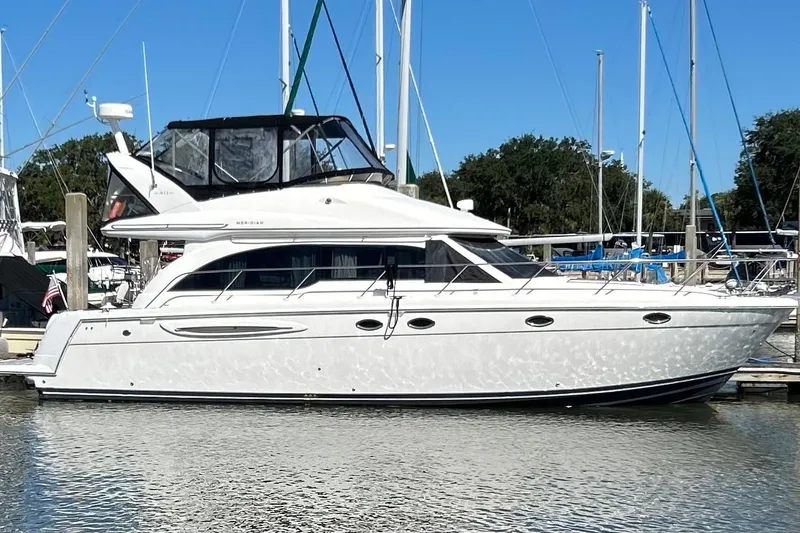 Slide: The Image of 2007 Meridian 411SB yacht docked at marina under clear blue sky. - 4
