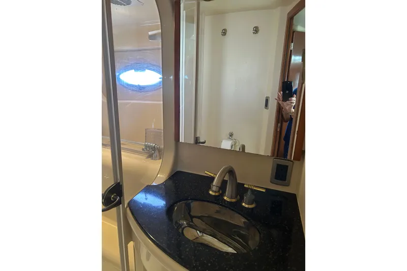 Slide: The Image of Luxurious bathroom in 2007 Meridian 411SB yacht with sleek black countertop. - 46