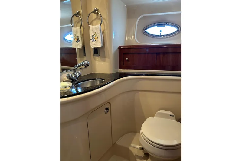 Slide: The Image of Luxurious bathroom in 2007 Meridian 411SB yacht with sink, toilet, and porthole window. - 48