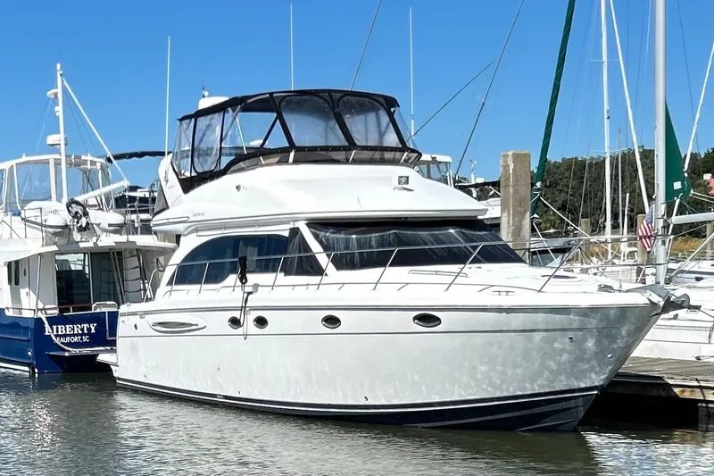 Slide: The Image of 2007 Meridian 411SB yacht docked in marina under clear blue sky. - 5