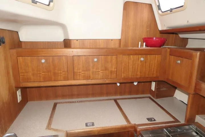 Slide: The Image of Interior of 1999 Hunter 450 Passage sailboat with wooden cabinets and countertop. - 16