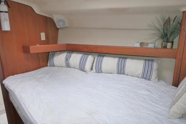 Slide: The Image of Cozy cabin interior of 1999 Hunter 450 Passage sailboat with bed and decor. - 24