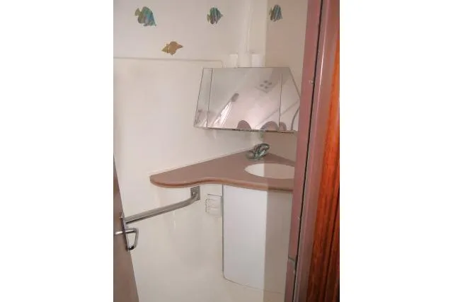 Slide: The Image of Bathroom interior of 1999 Hunter 450 Passage yacht with corner sink and mirror. - 32