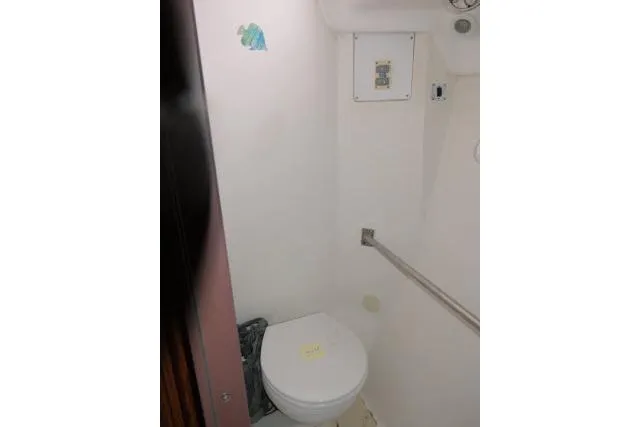Slide: The Image of Restroom interior of 1999 Hunter 450 Passage yacht, featuring a compact toilet. - 34