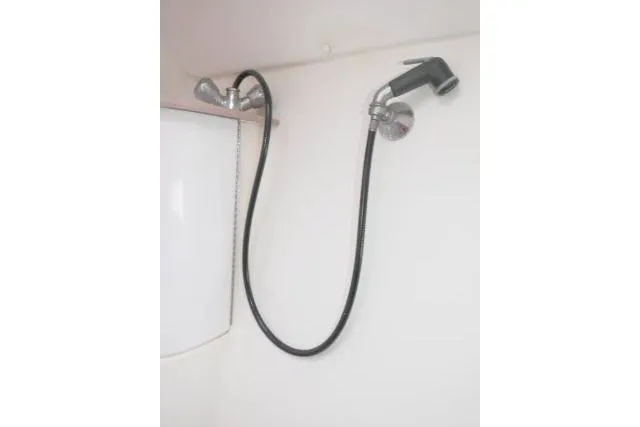 Slide: The Image of Showerhead in 1999 Hunter 450 Passage boat bathroom, featuring flexible hose and modern design. - 35
