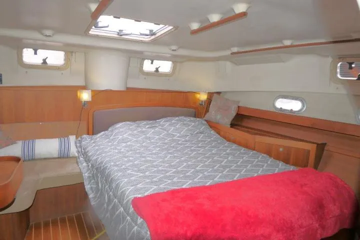 Slide: The Image of Cozy cabin interior of 1999 Hunter 450 Passage yacht with bed and wooden furnishings. - 36