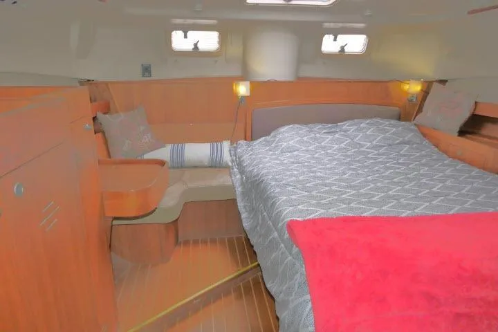 Slide: The Image of Cozy cabin interior of 1999 Hunter 450 Passage sailboat with bed and seating area. - 37