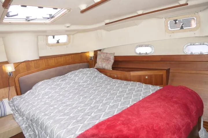 Slide: The Image of Cozy cabin interior of 1999 Hunter 450 Passage yacht with comfortable bed and wooden accents. - 39