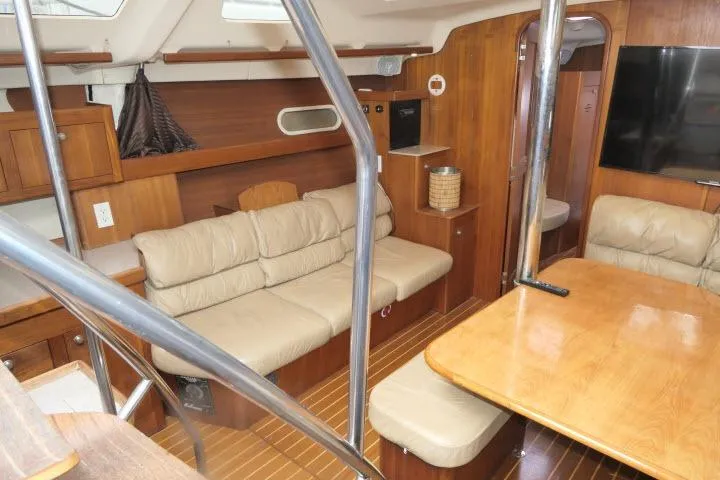 Slide: The Image of Interior of 1999 Hunter 450 Passage yacht with wooden furnishings and beige seating. - 4