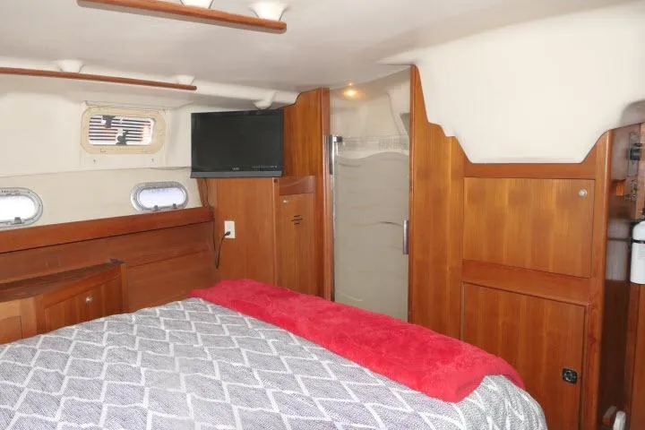 Slide: The Image of Interior of 1999 Hunter 450 Passage yacht with wood paneling and cozy bed. - 40