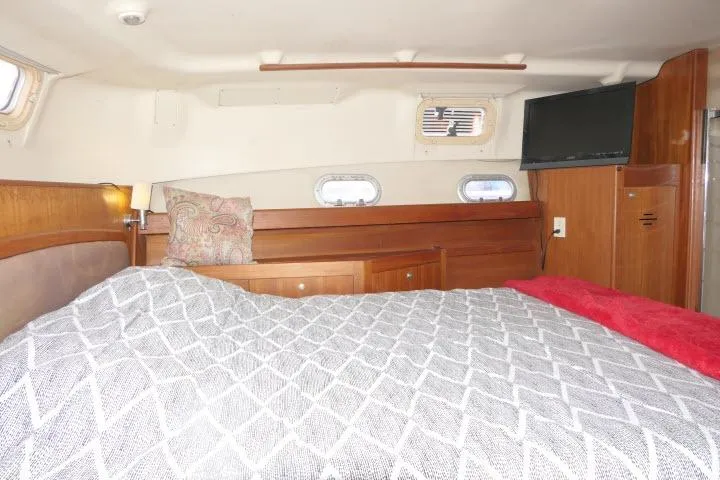 Slide: The Image of Cozy cabin interior of 1999 Hunter 450 Passage yacht with bed and portholes. - 41